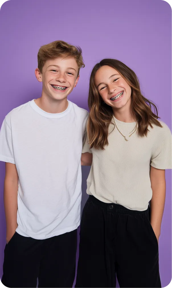 Smiling teenage boy and young girl