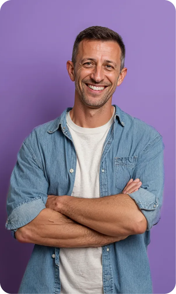 Smiling man with crossed arms in a denim shirt