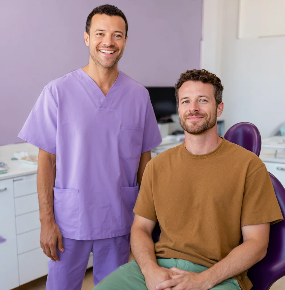 Dentist and a patient smiling in the clinic