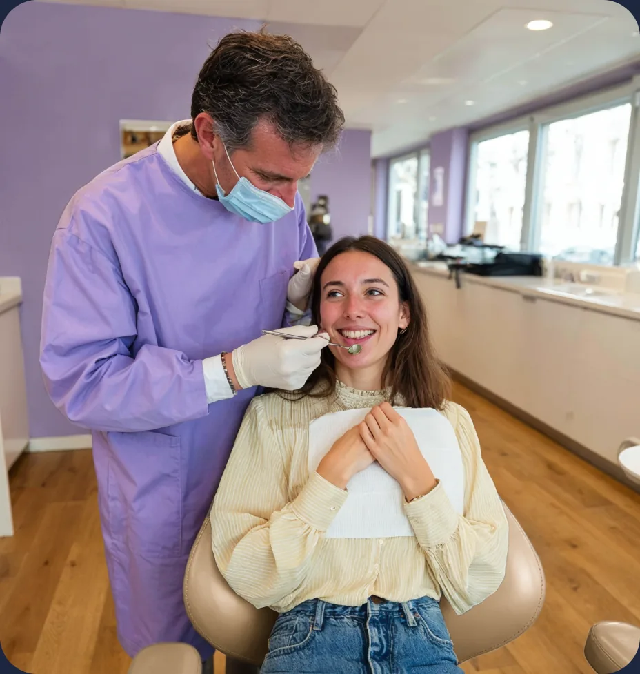 A dentist examining a smiling patient in the Dentalflow clinic