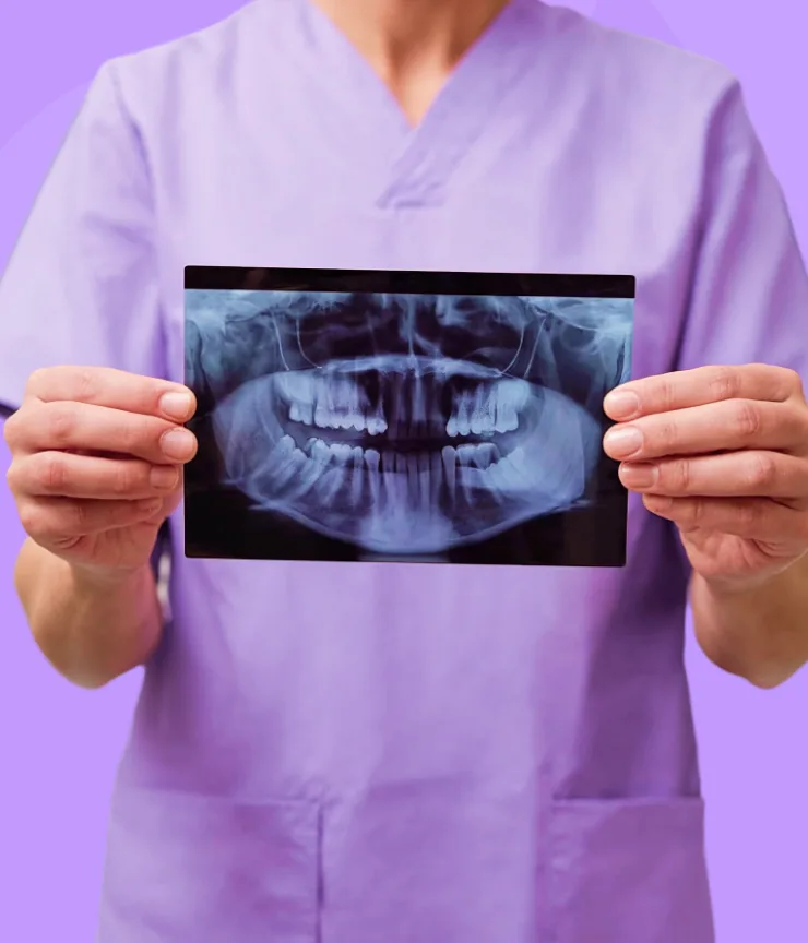 Dentist holding a dental X-ray