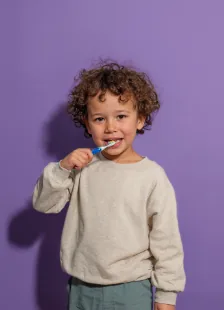 Young boy brushing his teeth