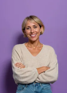 Smiling woman with crossed arms