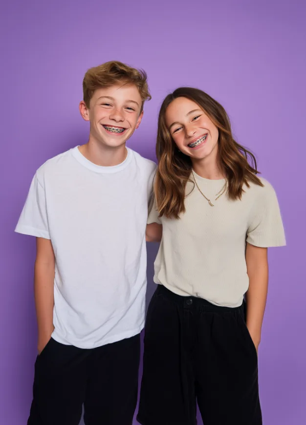 Two smiling teenagers with braces